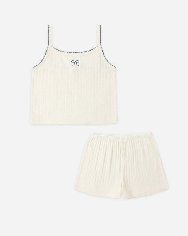 Cream-colored tank top and shorts set on a white background