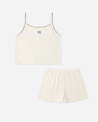 Cream-colored tank top and shorts set on a white background