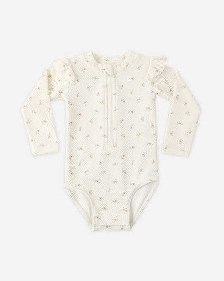 Baby onesie with long sleeves on a white background