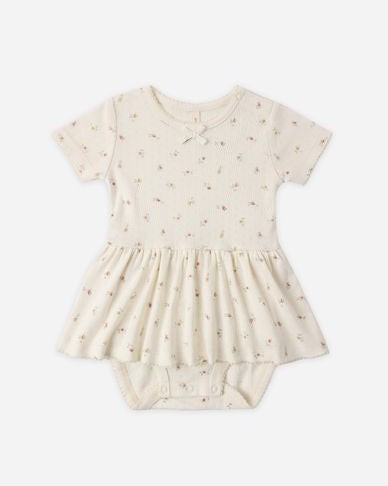 Baby romper with short sleeves and a skirt on a white background