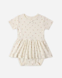 Baby romper with short sleeves and a skirt on a white background